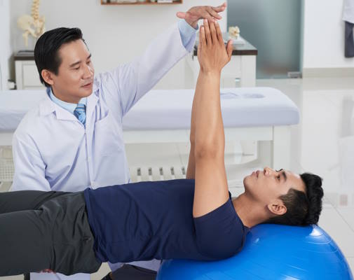 Man on an exercise ball - physiotherapy